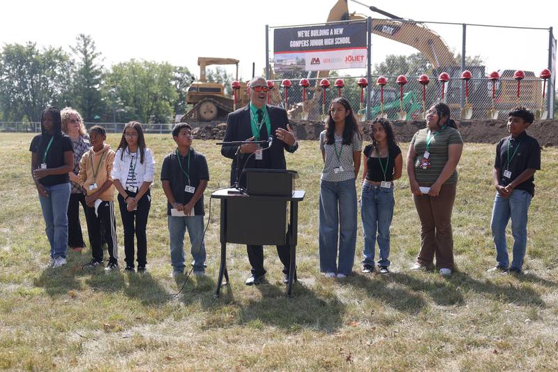 Gompers Junior High School students stand with Principal Raul Gaston as he speaks at the District 86 ground breaking ceremony for Gompers Junior High School on Thursday, Sept. 12, 2024 in Joliet.