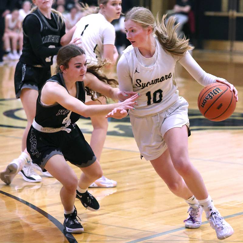 Sycamore's Lexi Carlsen tries to drive by Kaneland's Madison Schrader during their Class 3A sectional semifinal Tuesday, Feb. 20, 2024, at Sycamore High School.