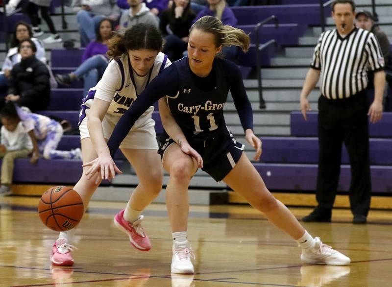 Cary-Grove's Kayli McMorris knocks the ball away from Hampshire's Ashley Herzing during a Fox Valley Conference girls basketball game Friday, Jan. 26, 2024, at Hampshire High School.