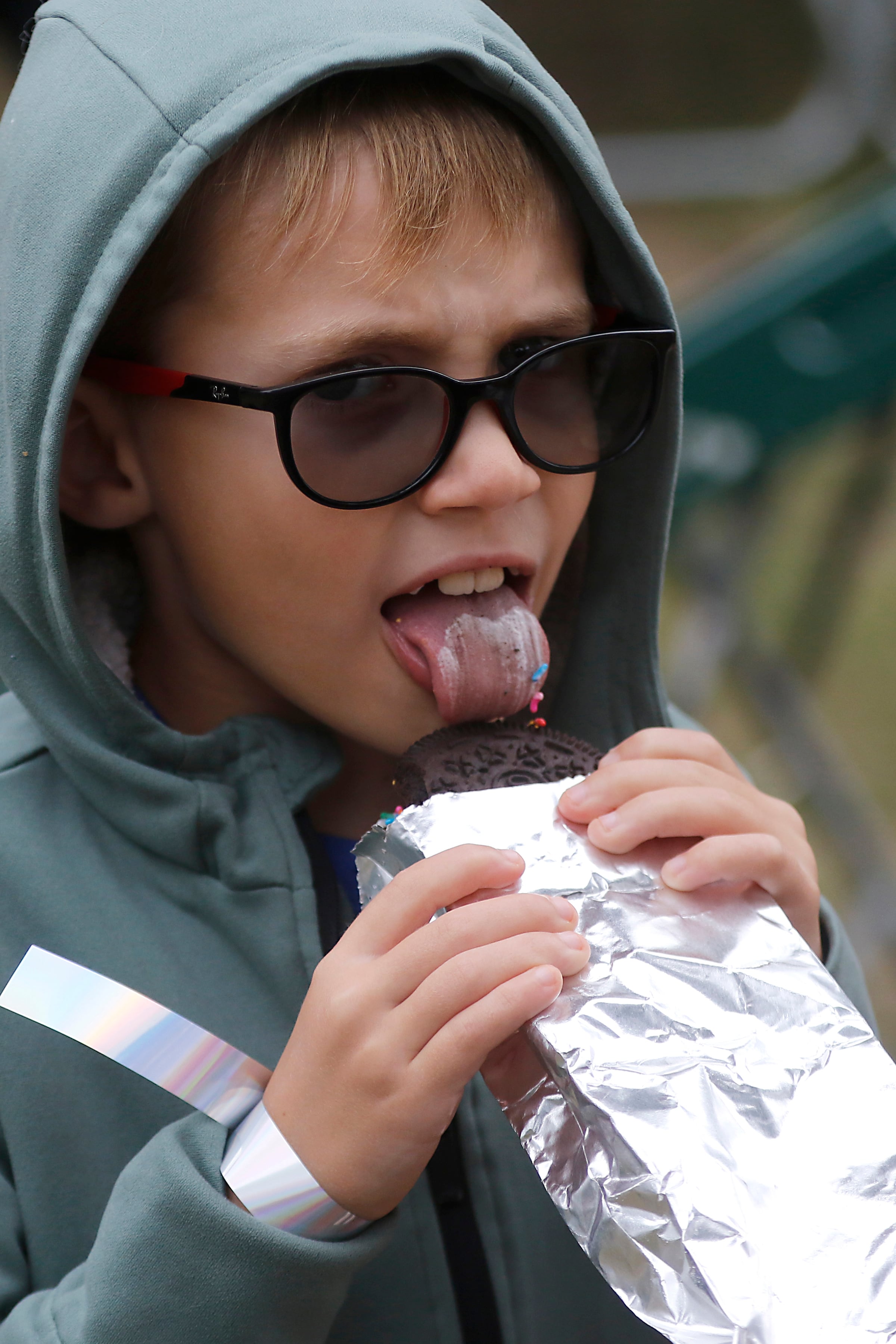 Caleb Handler, 7, enjoys a monster ice cream cookie during the Ice Cream Fest on Friday, Aug. 9, 2024, at Crystal Lake’s Main Beach.  The second annual event featured music, ice cream venders and an ice cream eating contest.