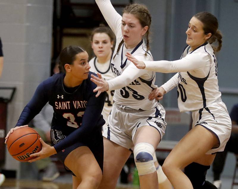 Cary-Grove's Ellie Mjaanes (center) and Sam Skerl (right) guard St. Viator's Mia Bergstrom during an IHSA Class 3A Antioch Sectional semifinal girls basketball game on Tuesday, Feb. 20, 2024, at Antioch High School.