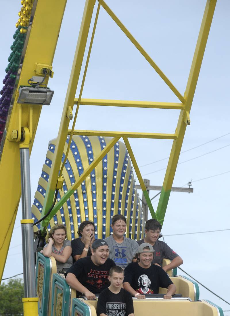 A group of teens appear to enjoy themselves Thursday, July 7, 2022, as they ride “Pharo’s Fury” during the Marseilles Fun Days carnival. The carnival continues through Saturday on Lincoln Street.