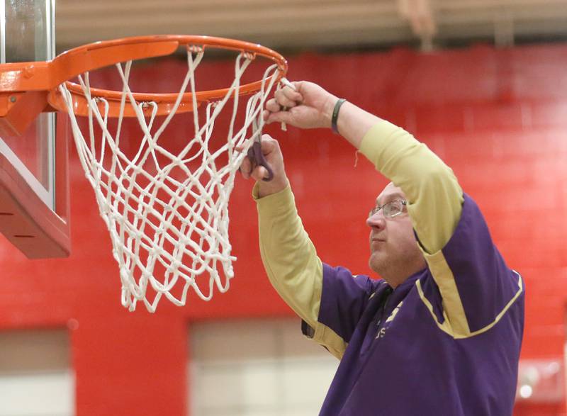 Serena head girls basketball coach Jim Jobst cuts a piece of the net down after defeating Ashton-Franklin Center in the Class 1A Regional on Thursday, Feb. 15, 2024 at Earlville High School.