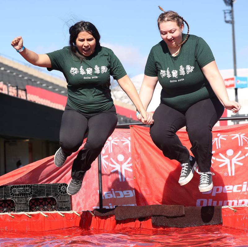 Members of the Delta Zeta sorority leap into the water on a cold and windy Saturday, Feb 17, 2024, during the Huskie Stadium Polar Plunge at Northern Illinois University in DeKalb. The Polar Plunge is the signature fundraiser for Special Olympics Illinois.