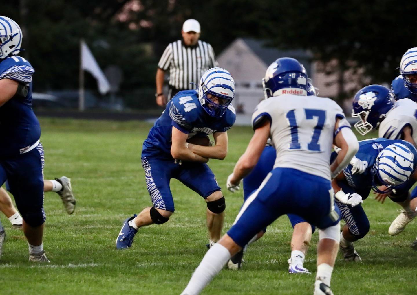 Alex Winn (44) looks for running space against the Newman defense and  George Junderman Friday night at Bryant Field. The Tigers won 28-14.