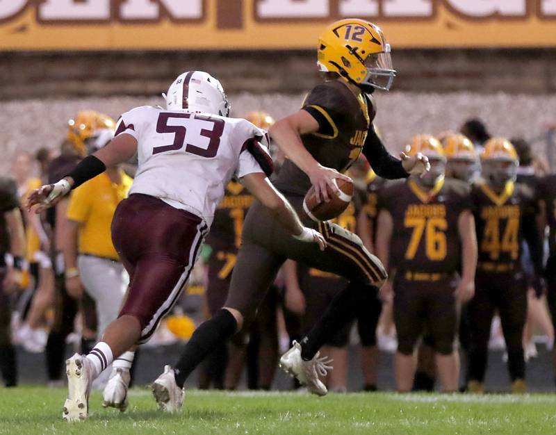 Prairie Ridge's Jose Esparza chases downs Jacobs' Connor Goehring during a Fox Valley Conference football game on Friday, Aug 30, 2024, at Jacobs High School in Algonquin.