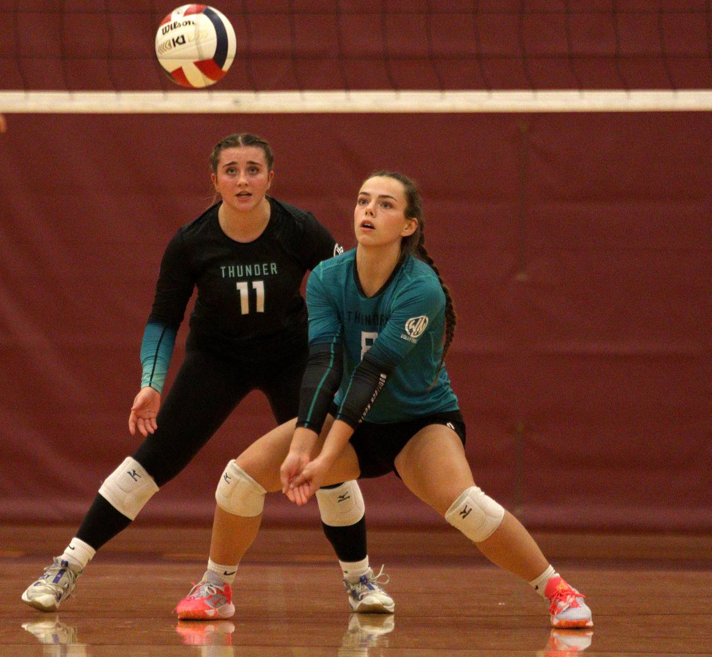 Woodstock North’s Madison Sofie, left, and Jayden Johnson prepare for the ball in varsity volleyball on Monday, Sept. 16, 2024, at Richmond-Burton High School in Richmond.