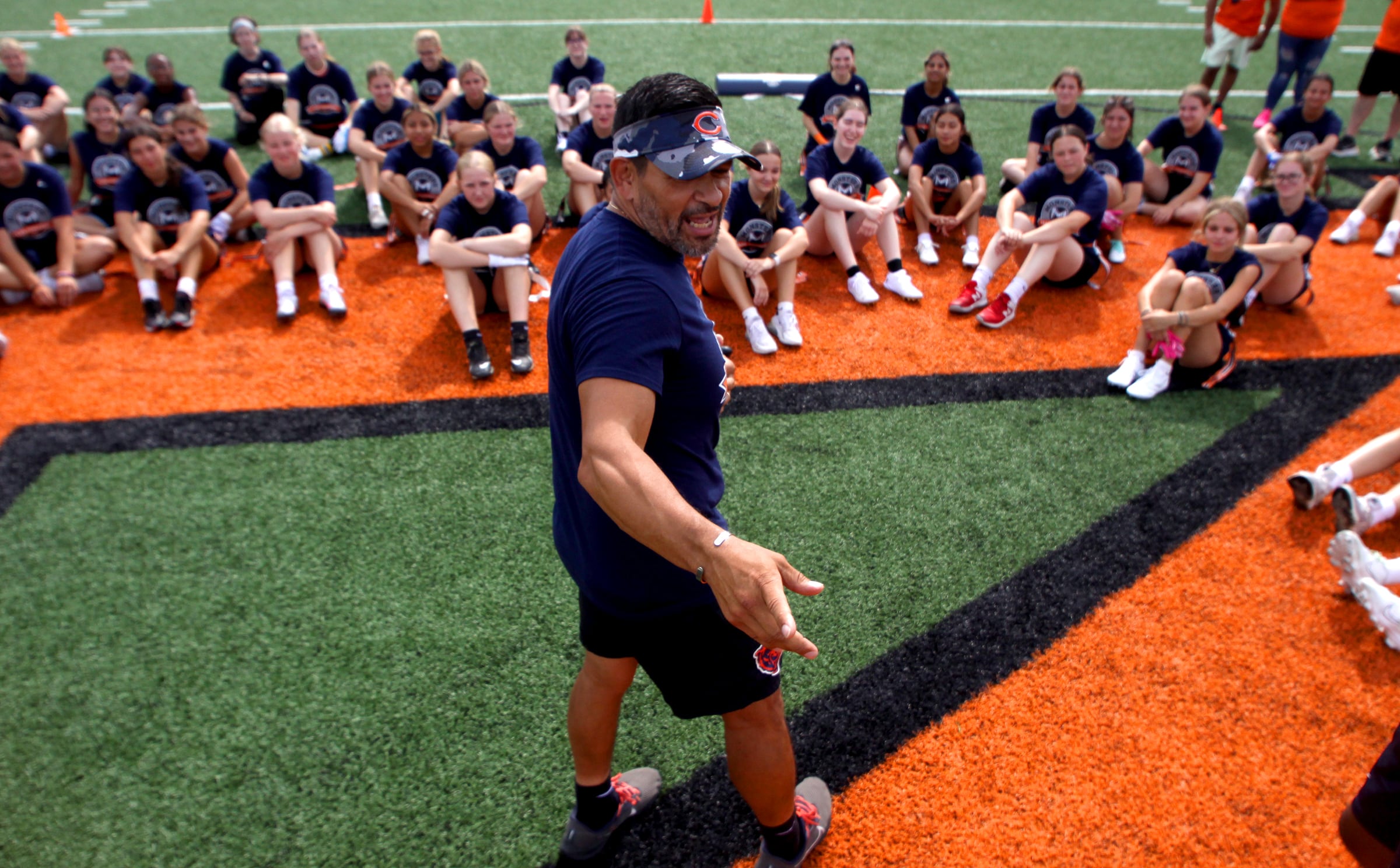 Gustavo Silva, manager of youth and high school football for the Chicago Bears, greets athletes as the Chicago Bears and McHenry Community High School hosted a flag football clinic at McCracken Field Wednesday, July 31, 2024.