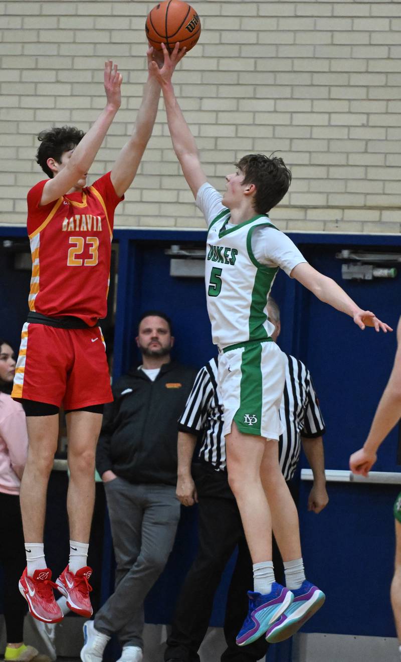 York’s Kyle Waltz, right, blocks a shot by Batavia’s Jax Abalos during the Addison Trail Class 4A boys basketball sectional semifinal on Wednesday, Feb. 28, 2024 in Addison.