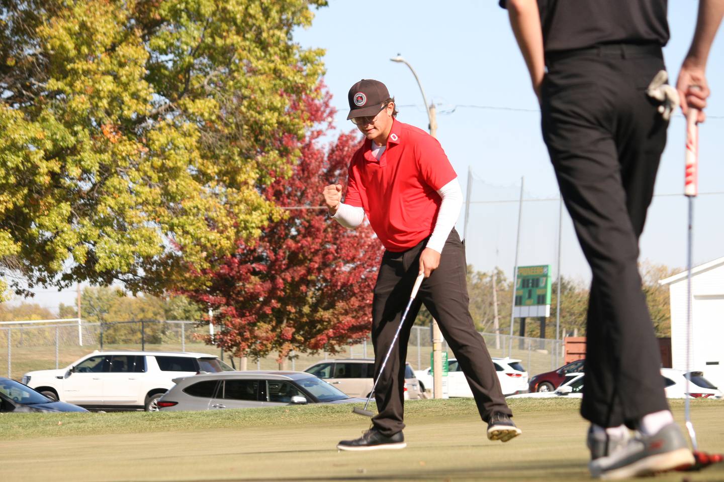 Ottawa's Jacob Armstrong fist pumps after making a critical par on the 18th hole of Weibring Golf Course on Saturday.