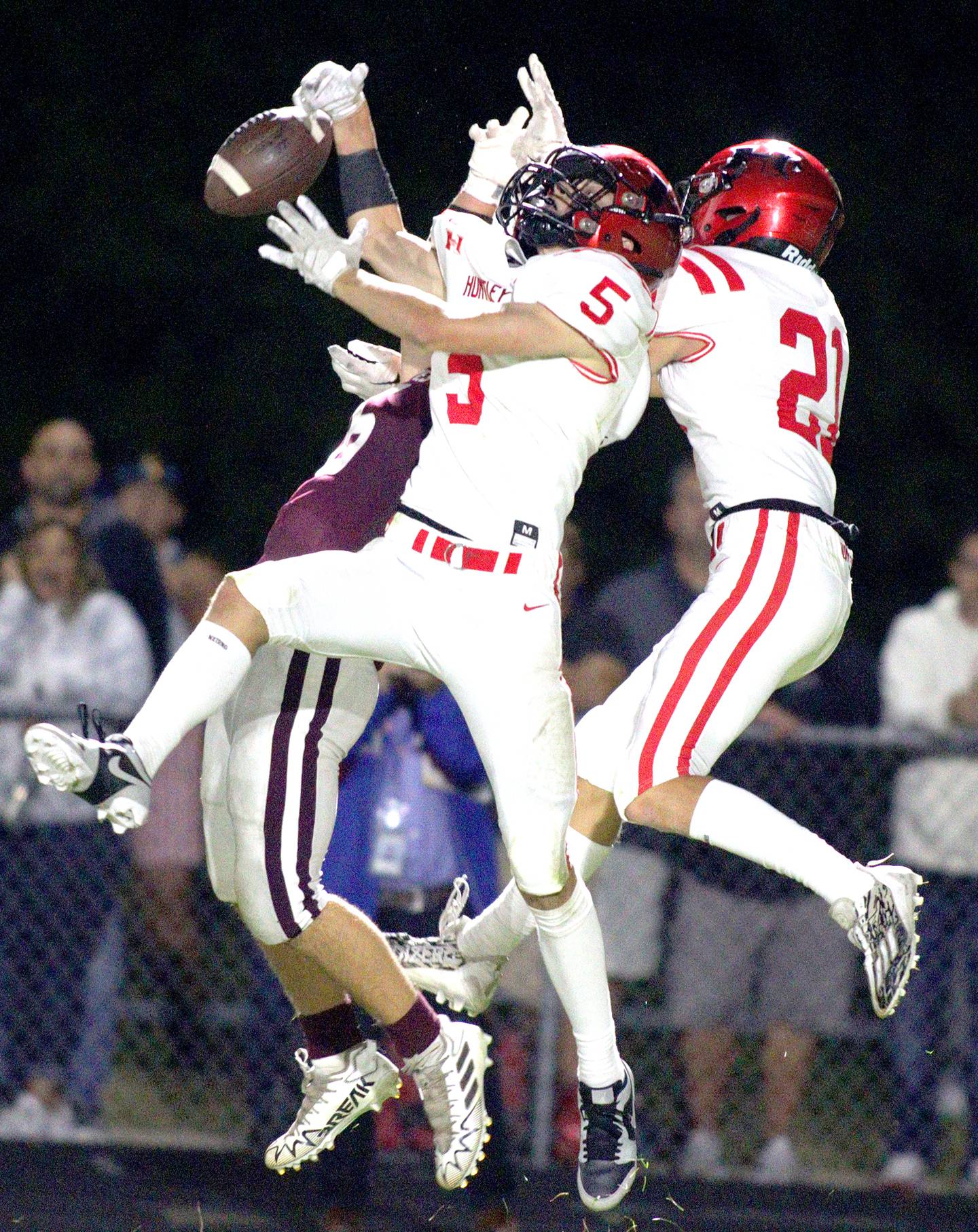 Huntley’s Zach Rysavy (5) and others go up for a pass against Prairie Ridge in varsity football at Crystal Lake Friday night.