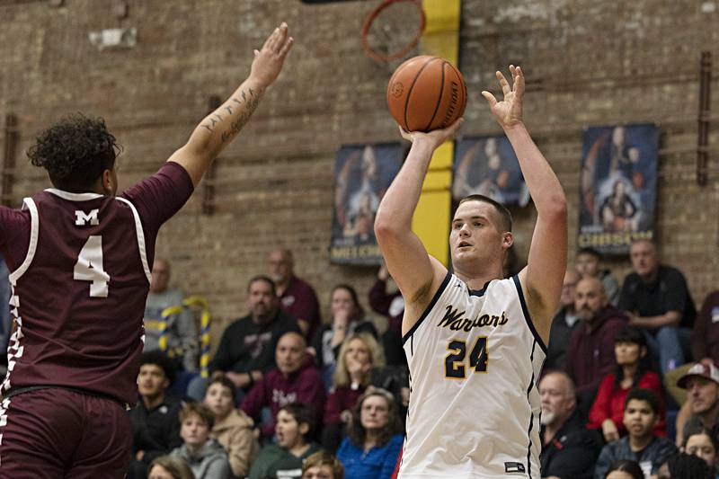 Sterling’s Lucas Austin puts up a shot against Moline’s Marcus McQueen Friday, Dec. 1, 2023 in Sterling.