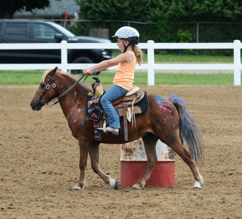 Leah Habben, 5, of Sterling, rides Evie around a barrel at the WHOA benefit horse show on Saturday, June 22, 2024 at the Whiteside County fairgrounds in Morrison.