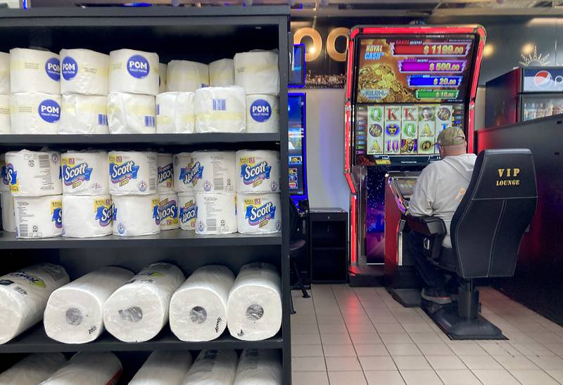 A mans plays a video gaming machine at the Shell convenience store across the street from the Thorntons truck stop in McHenry on Tuesday, April 2, 2024. The Thorntons location recently received a video gaming license from the McHenry City Council to become the first truck stop in the community to offer video gaming.