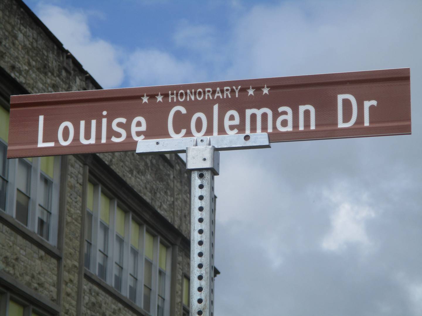 A sign marks the honorary designation of a section of Joliet Street between McDonough and Munroe streets as Louise Coleman Drive. Aug. 17, 2024