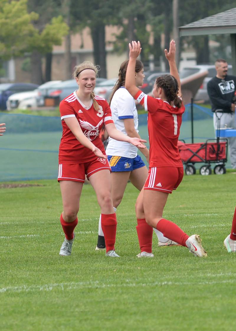 Oregon's Mya Engelkes (1)  and Debrorah Schmid (3) celebrate afte4r Schmid scored a goal to give the Hawks a 2-1 lead over Aurora Central Catholic at the 1A Oregon Regional on Tuesday, May 14, 2024. Oregon went on to win the game 4-1, advancing to the Shabbona (Indian Creek) Sectional on Saturday, May 18. The Hawks will face Stillman Valley in a noon game.