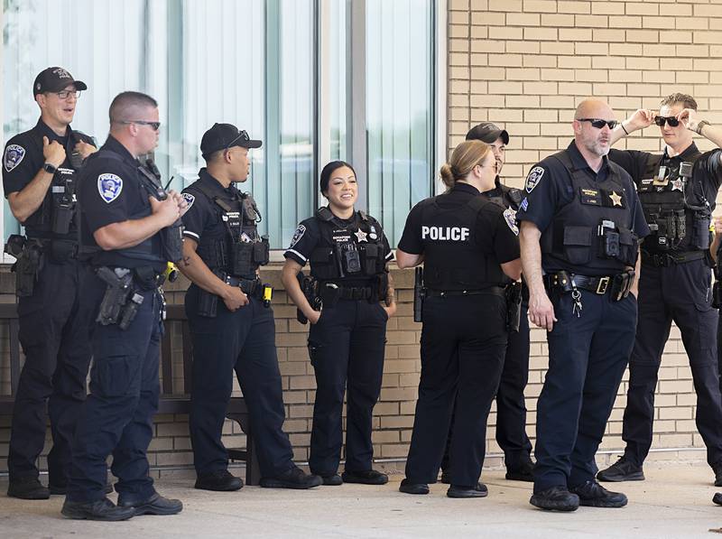 Rockford police officers wait outside OSF Medical Center in Rockford on Friday, June 14, 2024.