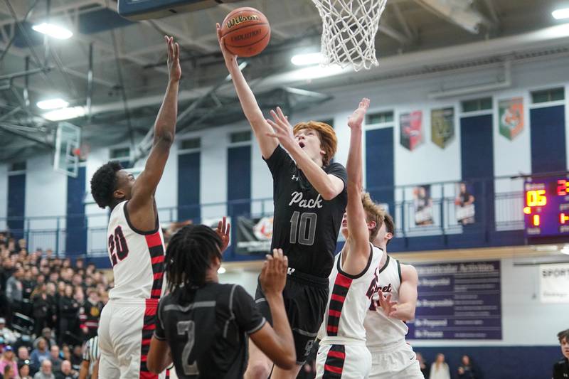 Oswego East's Noah Mason (10) shoots the ball in the post against Benet during a Class 4A Oswego East regional final basketball game at Oswego East High School on Friday, Feb 23, 2024.