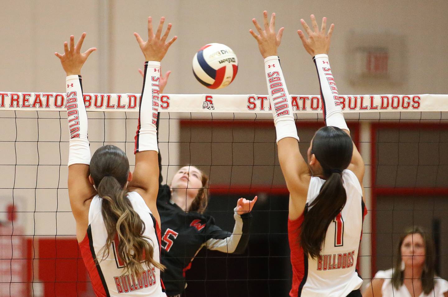 Woodland's Layna Wilcoxen gets the ball between Streator's Mya Zavada and teammate Aubrey Jacobs on Monday, Aug. 26, 2024 at Streator High School.