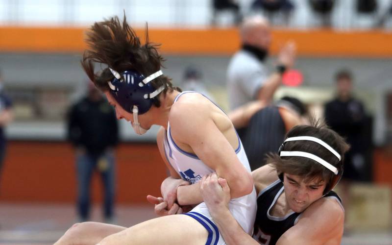 Prairie Ridge’s Tyler Evans, right, won the title bout at 120 pounds over Woodstock’s Caleb Sciame during IHSA Class 2A regional wrestling at Crystal Lake Central Saturday.