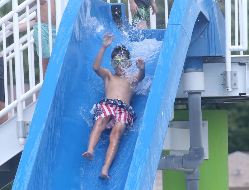 Ayven Michael of Peru slides down a slide into the water at Veterans Memorial Pool on Monday, June 17, 2024 in La Salle.