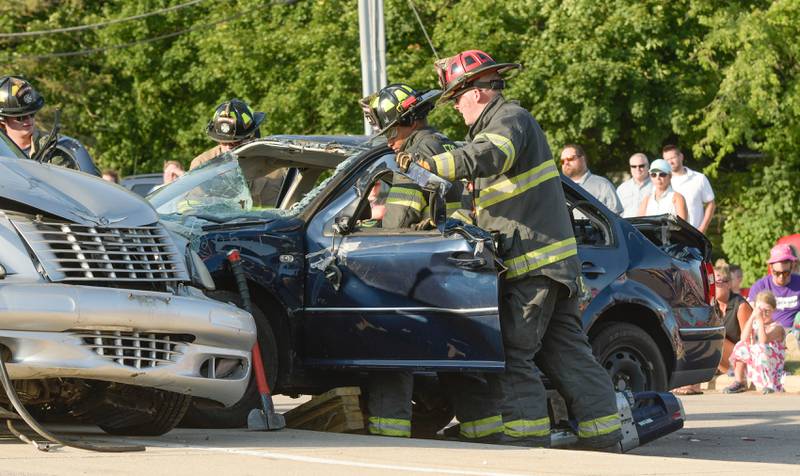 Fox River Countryside Firefighters demonstrate extricating a victim from a serious auto accident during the Campton Hills National Night Out event on Tuesday, August 2, 2022.