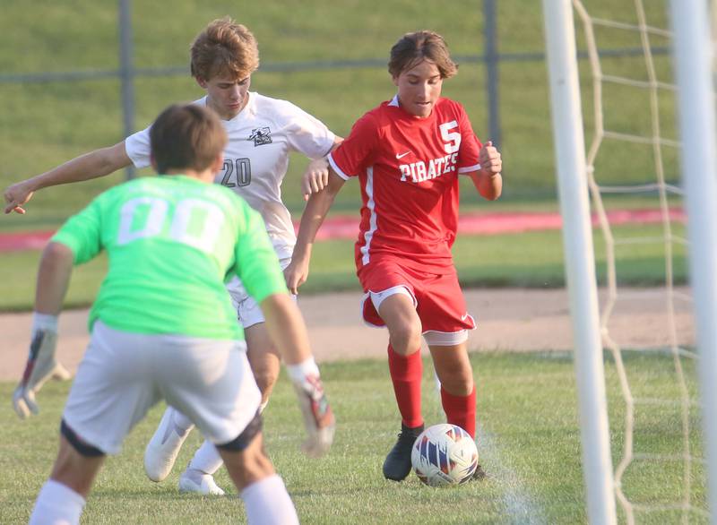 Ottawa's Rory Morre keeps the ball in bounce as Kaneland's Jackson Boryc and keeper Cooper Van Wagoner looks to stop the shot on Wednesday, Sept. 11, 2024 at King Field.