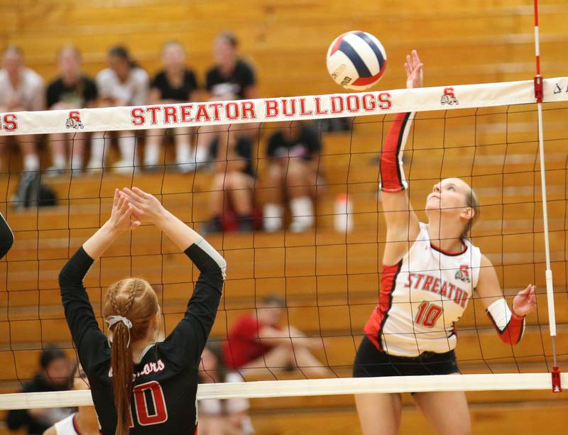 Streator's Shaelyn Groesbeck spikes the ball past Woodland's Gabby Jacobs on Monday, Aug. 26, 2024 at Streator High School.