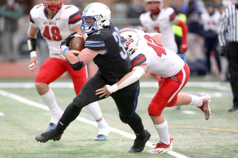 St. Charles North’s Jake Furtney carries the ball in the third quarter during their 7A quarterfinal game against St. Rita in St. Charles on Saturday, Nov. 12, 2022.