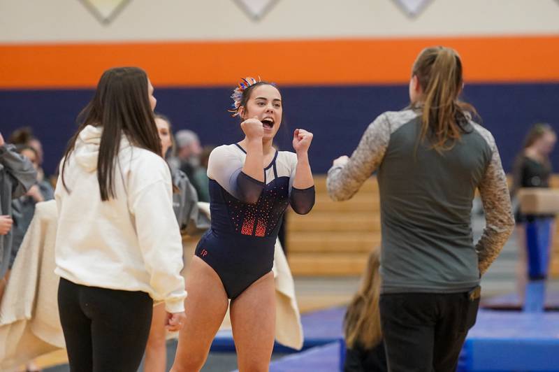 Oswego Co-op's Ava Sullivan reacts after hearing her score on the balance beam during a Oswego Regional Gymnastics Meet at Oswego High School on Monday, Jan 29, 2024.