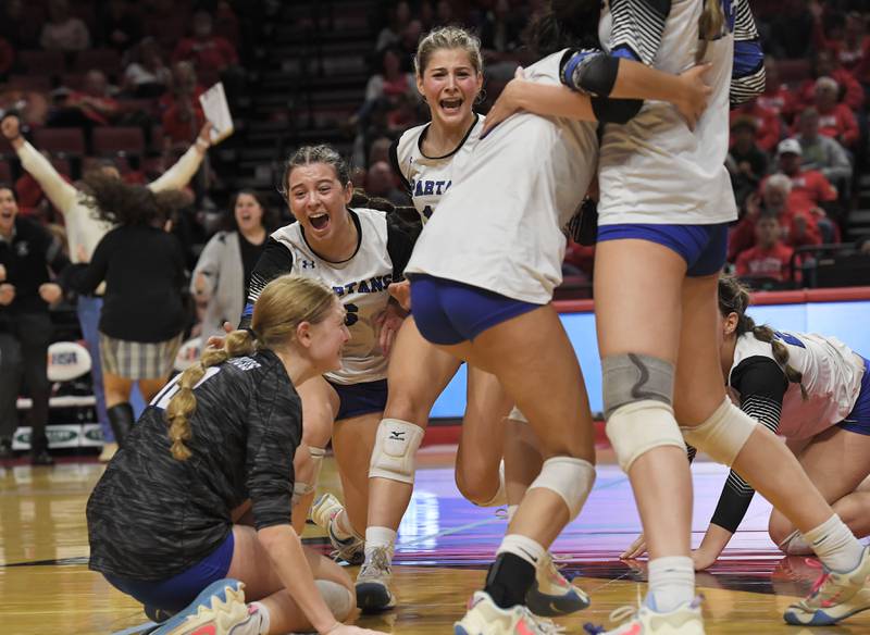 St. Francis’ Olivia Basel, middle, Anna Paquette, right, and Catherine D'Orazio, left, reacts with their teammates as they defeat Lincoln in the Class 3A girls volleyball state championship match at Illinois State University in Normal on Saturday, October 11, 2023.