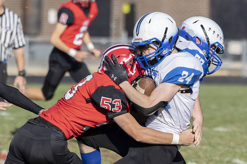 Blue Ridge’s Cole Pemble gets hit hard by Amboy’s Austin Heath in a first round playoff game Saturday, Oct. 29, 2022.