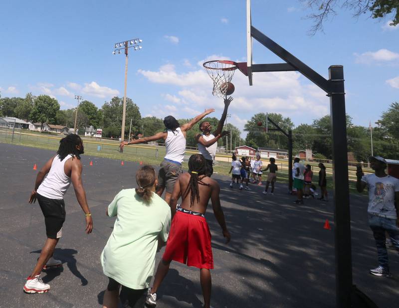 Youth play basketball during the Juneteenth event on Wednesday June 19, 2024 at Kirby Park in Spring Valley.