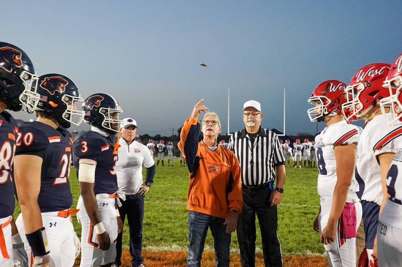 Former defensive coach of the 2003 state champion Oswego Panthers Dave Keely takes part in the coin toss prior to kickoff during a football game at Oswego High School against West Aurora on Friday, Sept. 29, 2023.