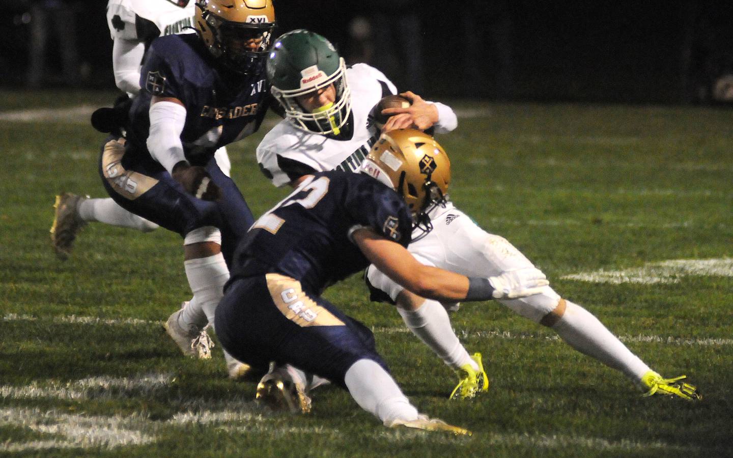 Seneca's Paxton Giertz is tackled by Marquette's Marcus Baker and Grant Dose (32) at Gould Stadium in a game last season.