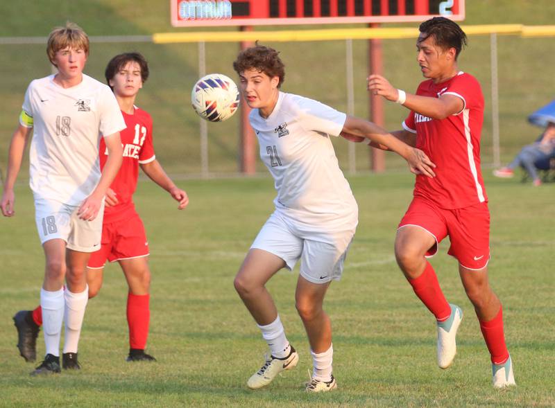 Kaneland's Manny Cepeda sprints to the ball as Ottawa's Jorge Lopez defends while Kaneland's Matthew Mitchinson and Quinn Rus watch from behind on Wednesday, Sept. 11, 2024 at King Field.