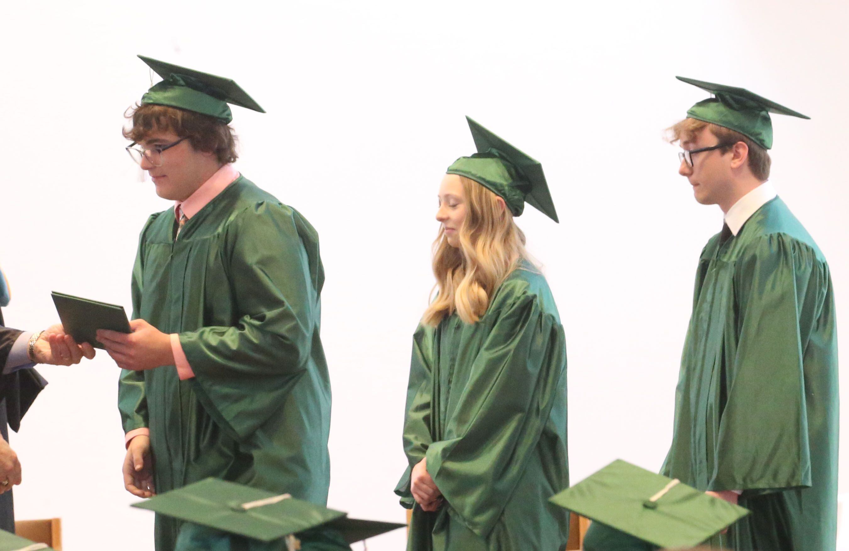 St. Bede graduates receive their diplomas during the Class of 2023 graduation ceremony on Sunday, May 21, 2023, in the Abbey Church at the academy.