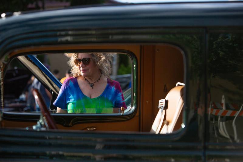 Nancy Brown of Willowbrook looks through he window of one of the classic cars during Cruisin’ Night in downtown Westmont, Thursday, June 6, 2024.