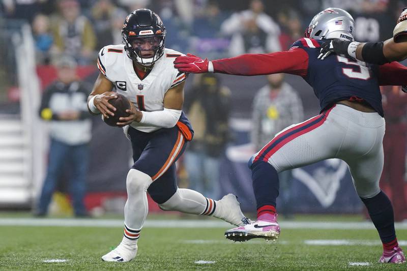 Chicago Bears quarterback Justin Fields eludes New England Patriots linebacker Matthew Judon during the second half, Monday, Oct. 24, 2022, in Foxborough, Mass.