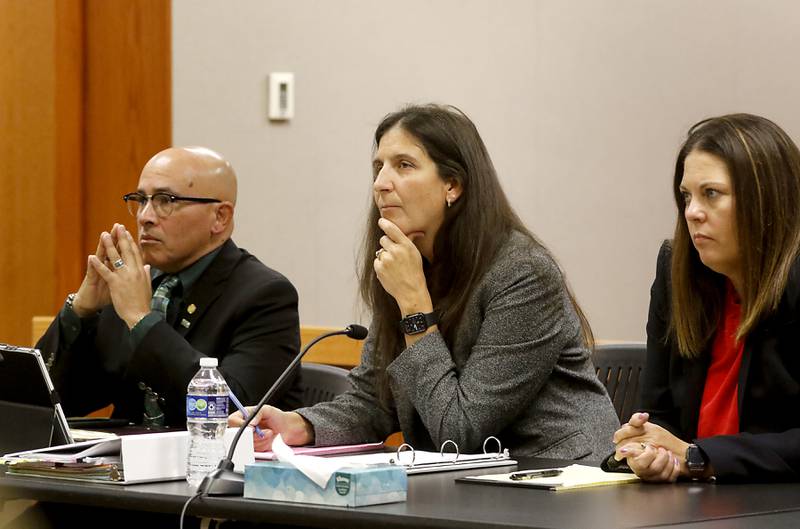 Carlos Acosta, defense attorney Rebecca Lee and defense attorney Jamie Wombacher listen as McHenry County State's Assistant Attorney Randi Freese delivers the state’s closing argument the during the trial for the former Illinois Department of Children and Family Services employees Acosta and Andrew Polovin before Lake County Judge George Strickland on Friday, Oct. 13, 2023, at the McHenry County Courthouse. Acosta was convicted of mishandling the case of 5-year-old AJ Freund of Crystal Lake before the boy was killed by his mother. Acosta was due to be sentenced June 6, 2024.