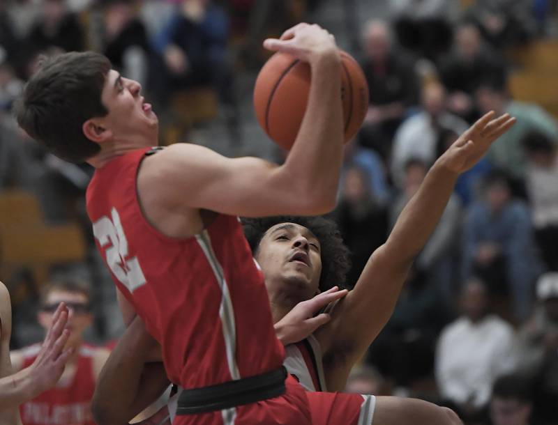 Palatine’s Tommy Elter gets a rebound against Yorkville’s Kaevian Johnson in a quarterfinal game of the Jack Tosh Classic at York High School in Elmhurst on Thursday, Dec. 28, 2023.