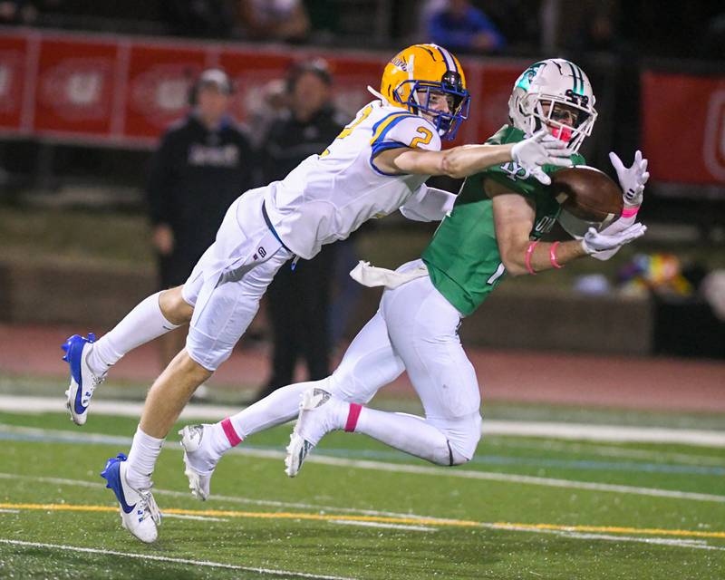 York’s Fintan Helm catches the ball for a first down while being defended by Lyons Township's Travis Stamm (2) on Friday Oct. 18, 2024, played at York High School in Elmhurst.