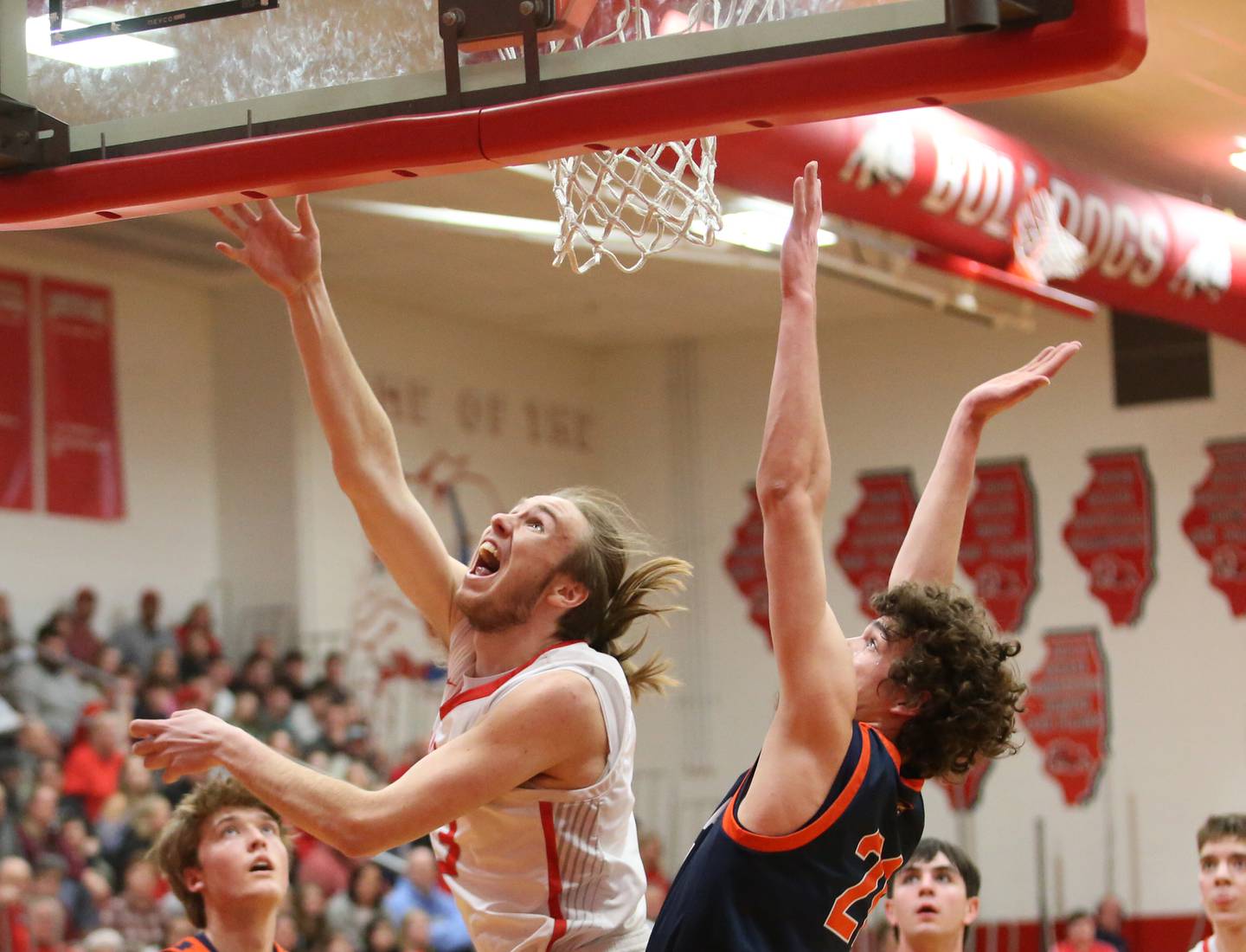 Streator's Quinn Baker (in white) tries layup over Pontiac's Riley Weber during the Class 3A Streator Regional semifinal Wednesday, Feb. 21, 2024, at Pops Dale Gymnasium