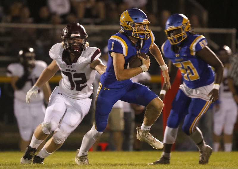 Johnsburg's AJ Bravieri runs away from Marengo’s Ryley Adamson during a Kishwaukee River Conference football game on Friday, Sept. 15, 2023, at Johnsburg High School.