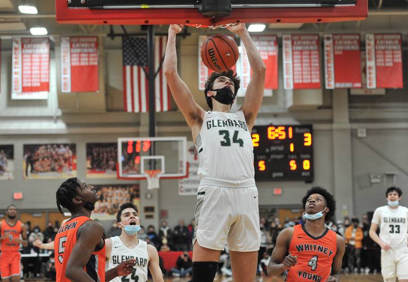 Glenbard West's Braden Huff (34) dunks the ball during a game on Jan. 22, 2022 at Benet Academy in Lisle.