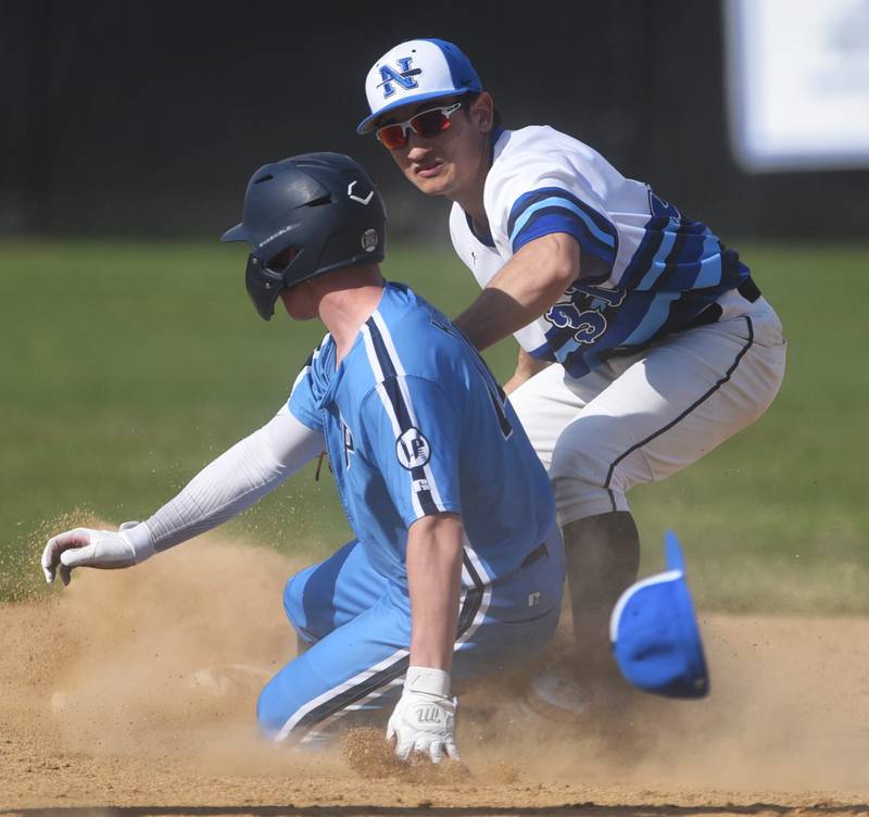 St. Charles North's Brad Lins, right, tags out Lake Park's Jason Keefe at second base during Friday’s baseball game in St. Charles.