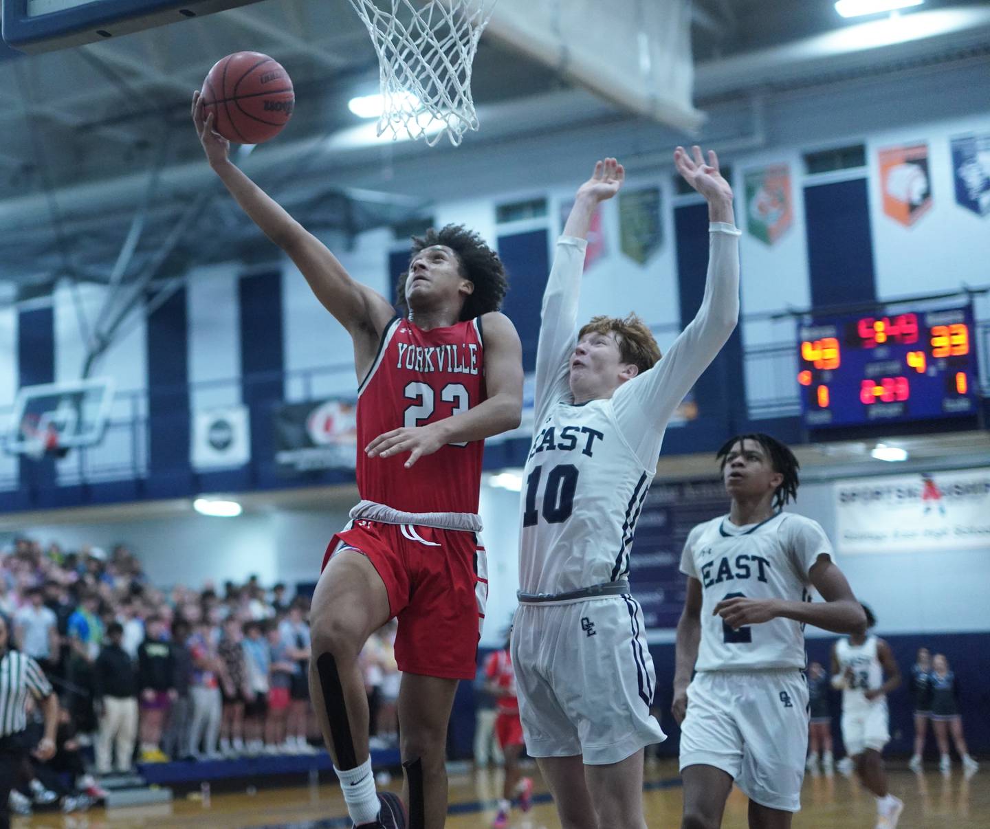 Yorkville's Jory Boley (23) drives to the hoop against Oswego East's Noah Mason (10) during a basketball game at Oswego East High School on Friday, Dec 8, 2023.