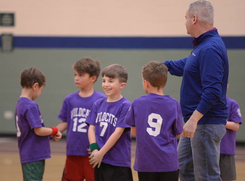 Children including Austin Guerrieri wait for coach Tim Pollard to start the game during a time out while participating in the Youth Basketball held at the LaGrange Park District Saturday, Jan 6, 2024.