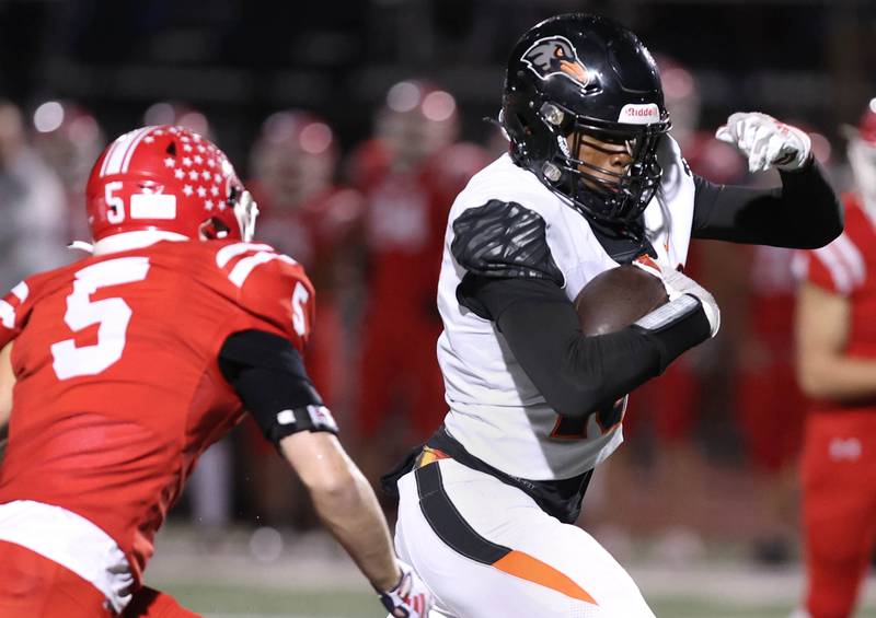 DeKalb’s Davon Grant gets by Naperville Central's Kaden Skarr after a catch during their game Friday, Oct. 6, 2023, at Naperville Central High School.