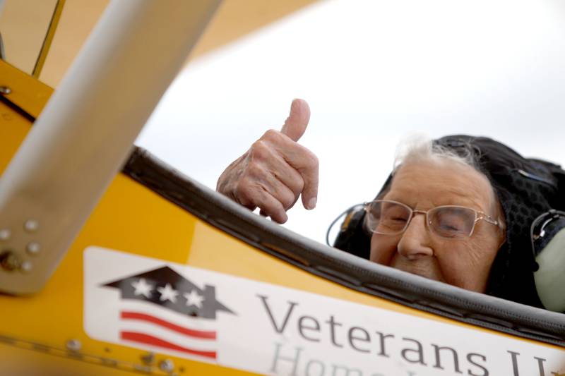 Helen Ehlers, 99, of Wheaton gives a “thumbs up” sign as she prepares to take off for a Dream Flight at the DuPage Airport in West Chicago on Saturday, July 29, 2023. The plane is a 1942 open cockpit Boeing Stearman, the same airplane used to train military aviators in the 1940s. The flights were courtesy of Ageless Aviation Dreams Foundation, a non-profit organization to honor U.S. military veterans living in long-term care facilities. Ehlers is a United States Marine Corps veteran.